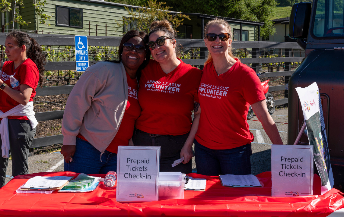 Three smiling JLOEB members at our annual fundraiser.