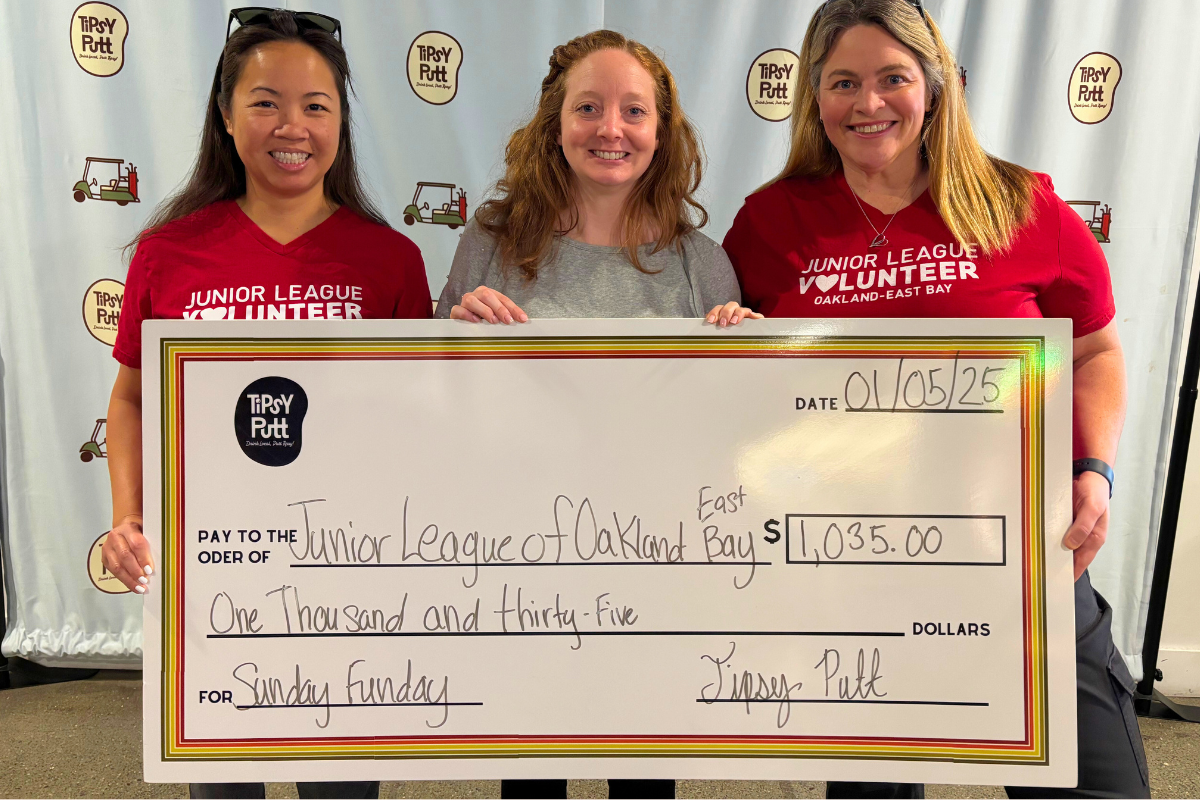 JLOEB Members accept a giant check from Tipsy Putt Emeryville fundraiser.